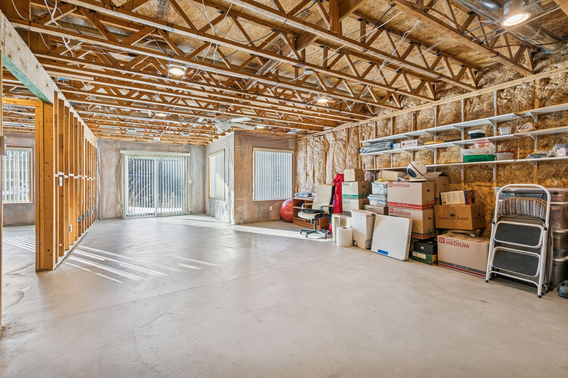 Unfinished lower level provides additional space ready for a second bedroom, and bathroom